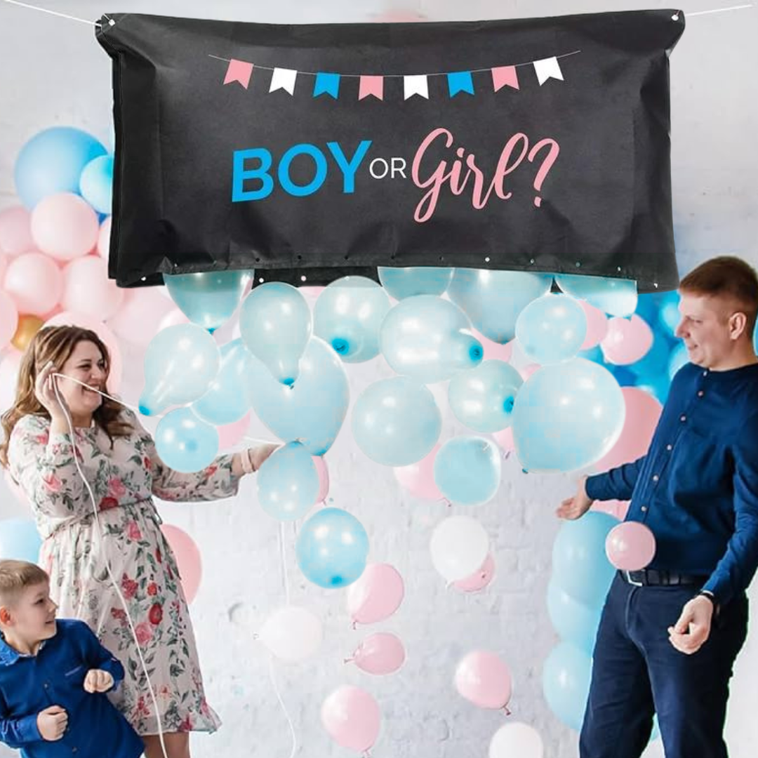 Family celebrating with a Boy or Girl? gender reveal balloon drop bag releasing blue balloons.