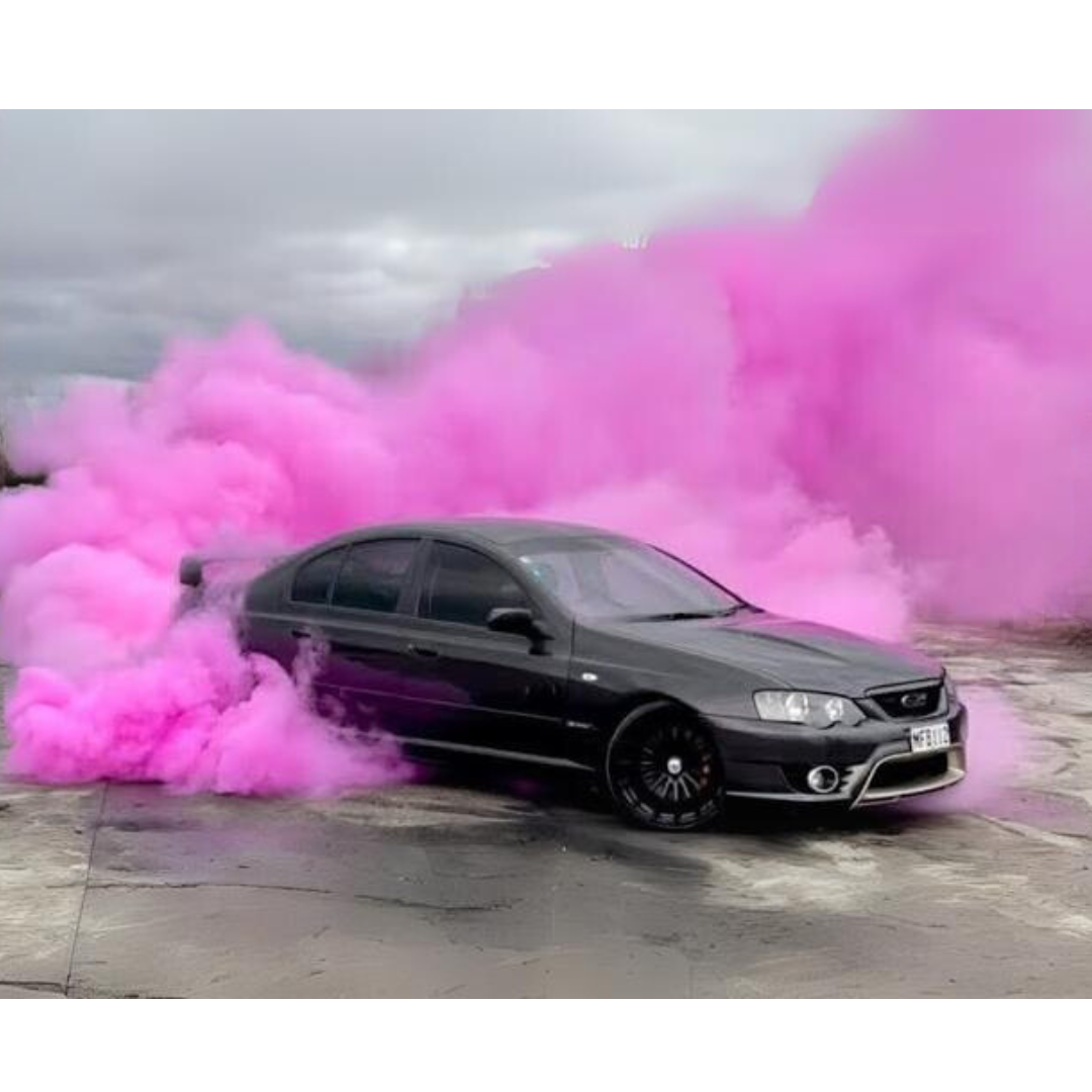 Australian Black car performing a gender reveal burnout with pink smoke for a reveal event