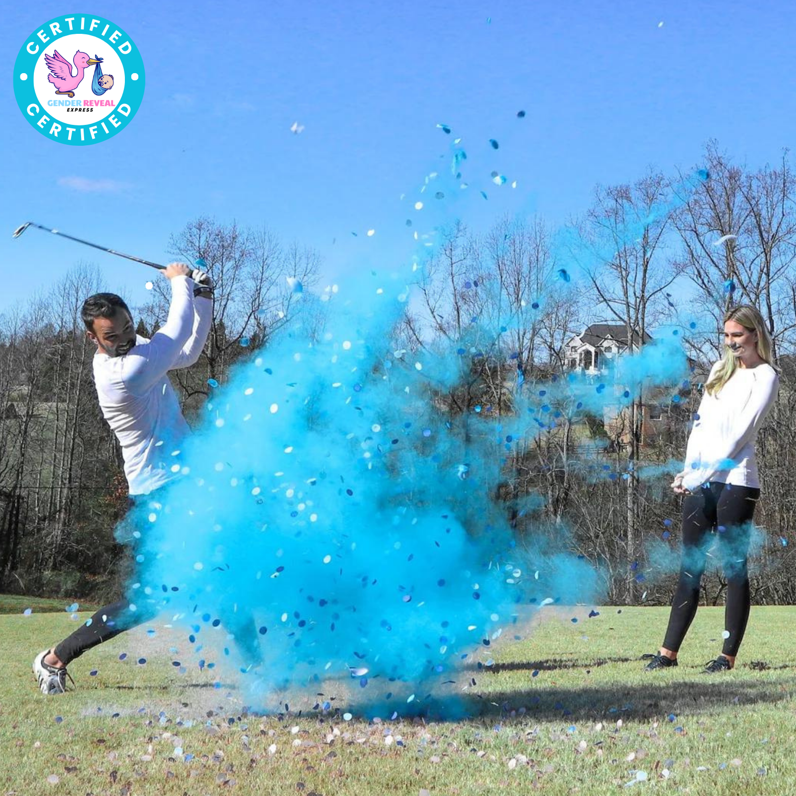 Man hitting Gender Reveal Golf Ball with blue powder and confetti explosion on a golf course