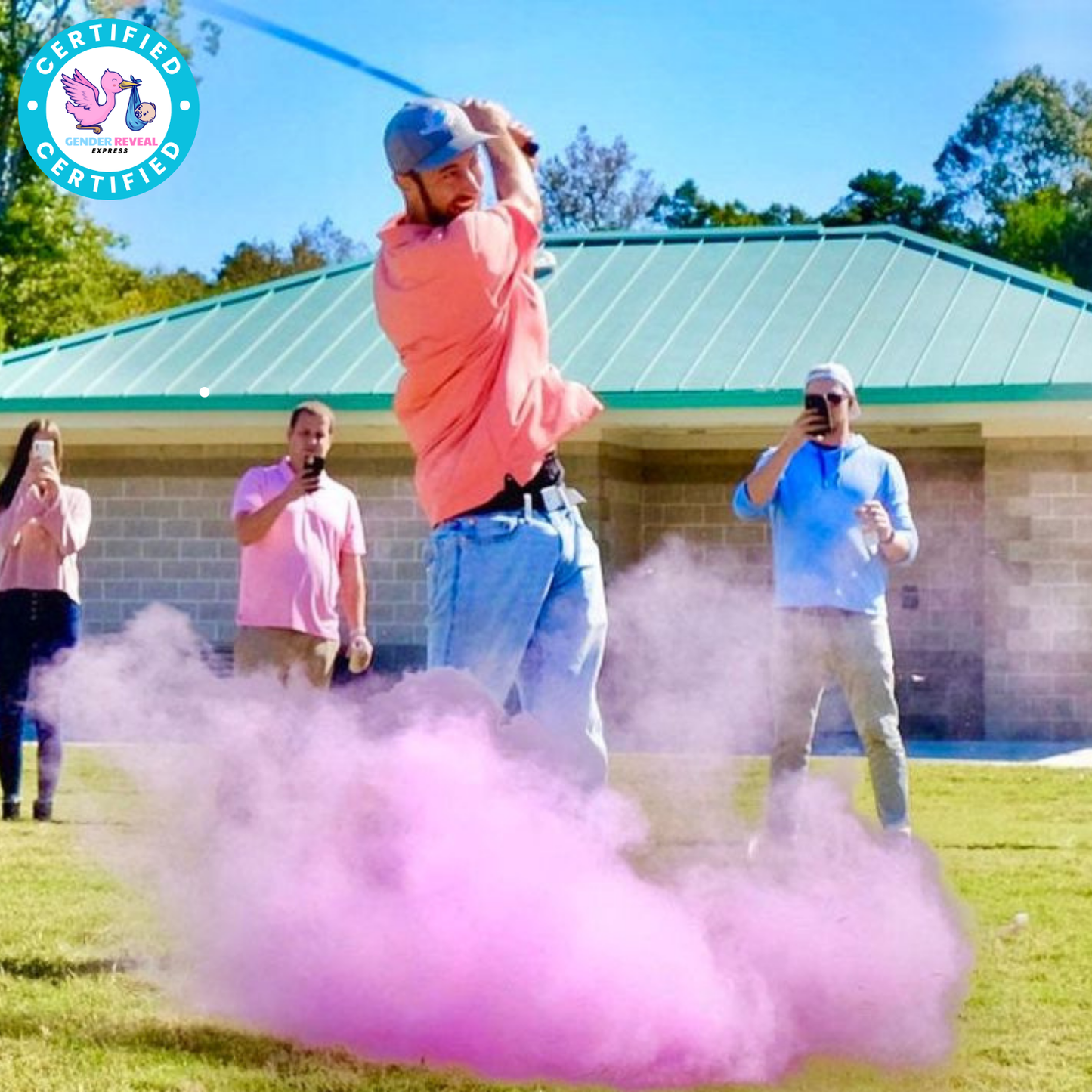 Man hitting Gender Reveal Golf Ball with pink powder explosion during a gender reveal party