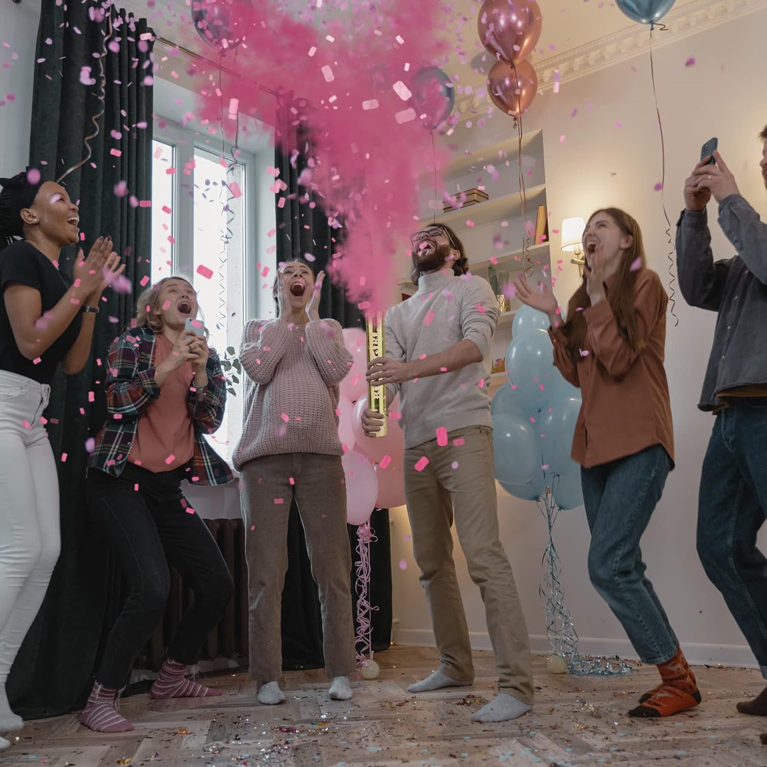 Group celebrating indoors with Luxury Gender Reveal Cannon releasing pink confetti and powder”